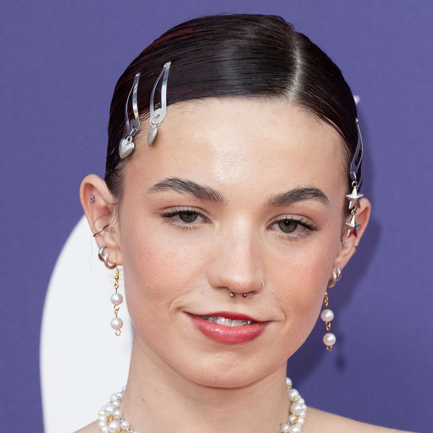 Lara Adkins attends Saltburn premiere wearing silver barrettes with dangling star and heart shaped charms