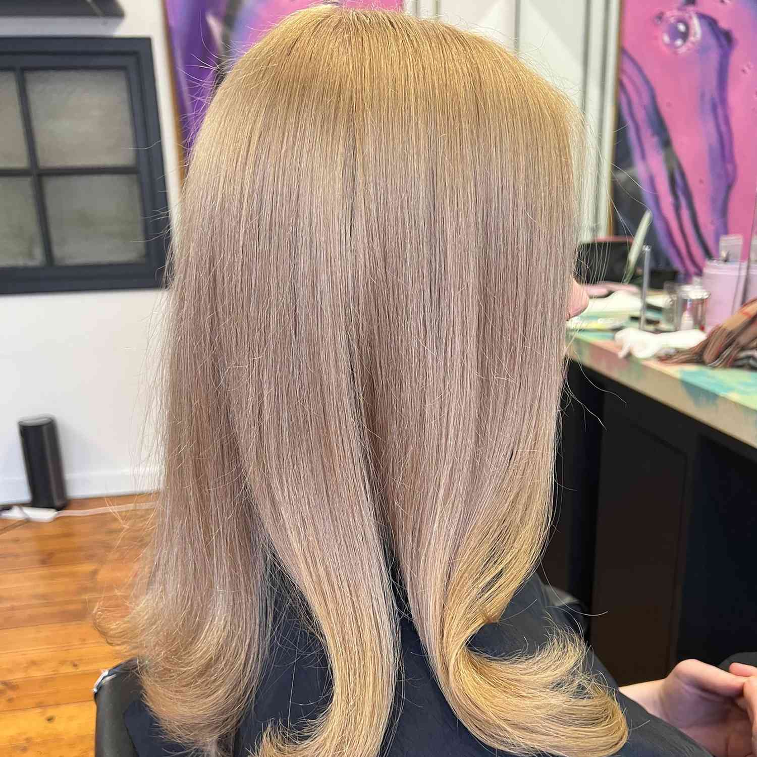 a natural blonde hair tone on straight hair, viewed in profile