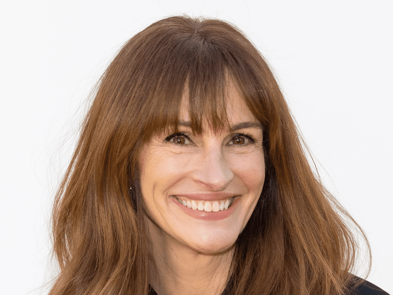 Julia Roberts with brown hair and bangs.